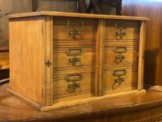 An Edwardian walnut Wellington type table top stationery chest, fitted two banks of three