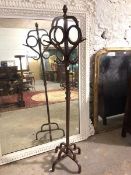 An early 20thc painted metal hallstand, of naturalistic form with acorn finial above eight hat pegs,