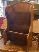 An oak floor standing two tier book trough c.1940, raised on shaped panel end supports (64cm x