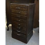 A stained pine eight drawer index cabinet, c.1940, on plinth base (95cm x 47vcm x 45cm)