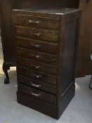 A stained pine eight drawer index cabinet, c.1940, on plinth base (95cm x 47vcm x 45cm)