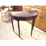 A reproduction demi lune table fitted single frieze drawer with serpentine front on reeded