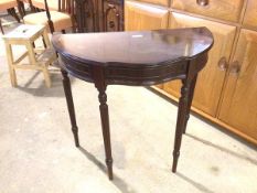 A reproduction demi lune table fitted single frieze drawer with serpentine front on reeded