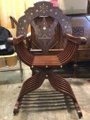 A late 20thc mahogany savonarola type chair, the arched crest rail above shaped splat and arms,