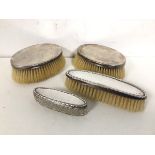 A group of three silver backed brushes (largest: 12cm x 8cm), a silver lidded oblong cut glass