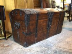 A 19thc Continental oak and iron bound trunk, the domed lid with pierced iron strapwork above a