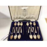 A set of twelve Sheffield silver coffee spoons, and a pair of sugar nips, in original box
