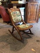 A small stained hardwood folding rocking chair with tapestry upholstered seat and back (80cm x