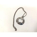 A Georg Jensen silver pendant of abstract form, stamps verso, on a cable chain (pendant: 6cm x 5cm)