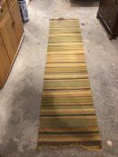A flatweave runner of varied striped design (300cm x 70cm)