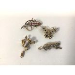 A group of four brooches, including a floral spray, butterfly, frog and tiger, three set diamond