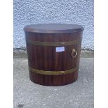 A 20thc mahogany lidded log or coal bucket, the brass bound tapering cylindrical body with carry