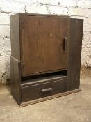 An Art Deco period stained hardwood chemist's cabinet, the door enclosing two shelves above a drawer