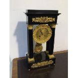 An early 20thc French Empire style portico clock, in ebonised case with gilt metal mounts, drum