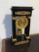 An early 20thc French Empire style portico clock, in ebonised case with gilt metal mounts, drum