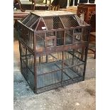 A large decorative Victorian bird cage, the sarcophagus shaped top with red and blue coloured