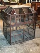 A large decorative Victorian bird cage, the sarcophagus shaped top with red and blue coloured