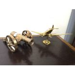 A 20thc cast brass model of a propeller driven aeroplane (h.14cm) together with a cast metal model