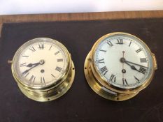 An early 20thc bulkhead type ship's wall clock in a brass and bevelled glass case, the white painted