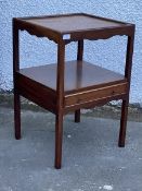 A Georgian style mahogany two tier washstand, the top with raised edge tray top over a shaped apron,