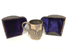 An 1897 London silver Christening mug with gadrooned body, in original case (a/f) (8cm) (124g)