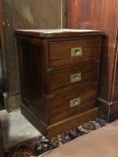 A mid to late 20thc mahogany campaign style bedside chest, fitted three drawers with recessed