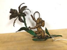 An early to mid 20thc wall light, gilt and painted metal, depicting a cherub on a flowering