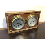 A Sestral ship's bulkhead type clock together with a Sestral aneroid barometer, both mounted on a