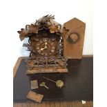 A late 19thc mantel top cuckoo clock, possibly Black Forrest, in a profusely carved case, with cut