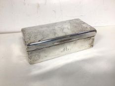 A London silver cigarette box, the hinged lid over a wooden interior (6cm x 18cm x 9cm)