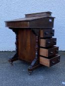 A Victorian inlaid walnut davenport, the raised hinged back revealing a plain interior, over a
