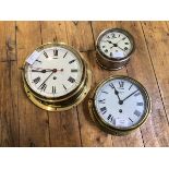 A Smith eight day bulkhead type clock in brass and glass case with white painted dial and Roman