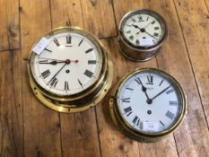 A Smith eight day bulkhead type clock in brass and glass case with white painted dial and Roman
