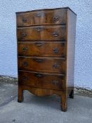 An early 20thc figured walnut serpentine tall chest of drawers in the Georgian taste, the moulded