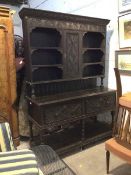 A Victorian carved oak dresser of an earlier design, the gadroon carved cushion cornice over a