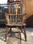 A 19thc double hoop and spindle back Windsor chair, of various fruitwoods, the splat back and saddle