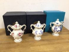 A collection of three Coalport pot pourri lidded vases, each of a matching design with various