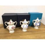 A collection of three Coalport pot pourri lidded vases, each of a matching design with various