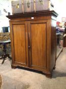 A Late 19thc mahogany dwarf press with dentil cornice above two panelled doors enclosing a shelf