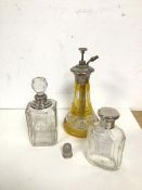 A group of toiletry bottles, one with silver collar, another with silver top, an atomiser with