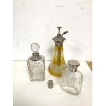 A group of toiletry bottles, one with silver collar, another with silver top, an atomiser with