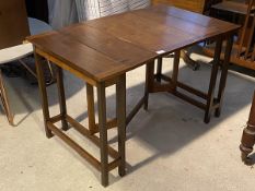 An unusual walnut metamorphic occasional table, first half of the 20thc., the top lifting and