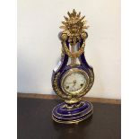 A blue porcelain and gilt metal lyre form mantel clock, a replica of the Marie Antoinette clock