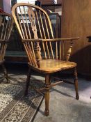 A 19thc elm, ash and beech double hoop back Windsor chair, with saddle seat, raised on turned