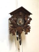 A 20thc West German cuckoo clock striking the hours and halves hammer on coil