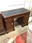 An Edwardian mahogany twin pedestal writing desk, the top inset with tooled skiver, above one long