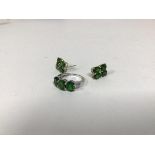 A dress ring marked 9k, set three green stones and diamond chips to shoulder (O) and two earrings,