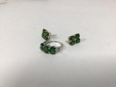 A dress ring marked 9k, set three green stones and diamond chips to shoulder (O) and two earrings,