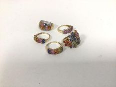 A group of five rings, all marked 375 or 9k, four with polychrome settings, one with pink setting,