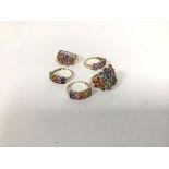 A group of five rings, all marked 375 or 9k, four with polychrome settings, one with pink setting,